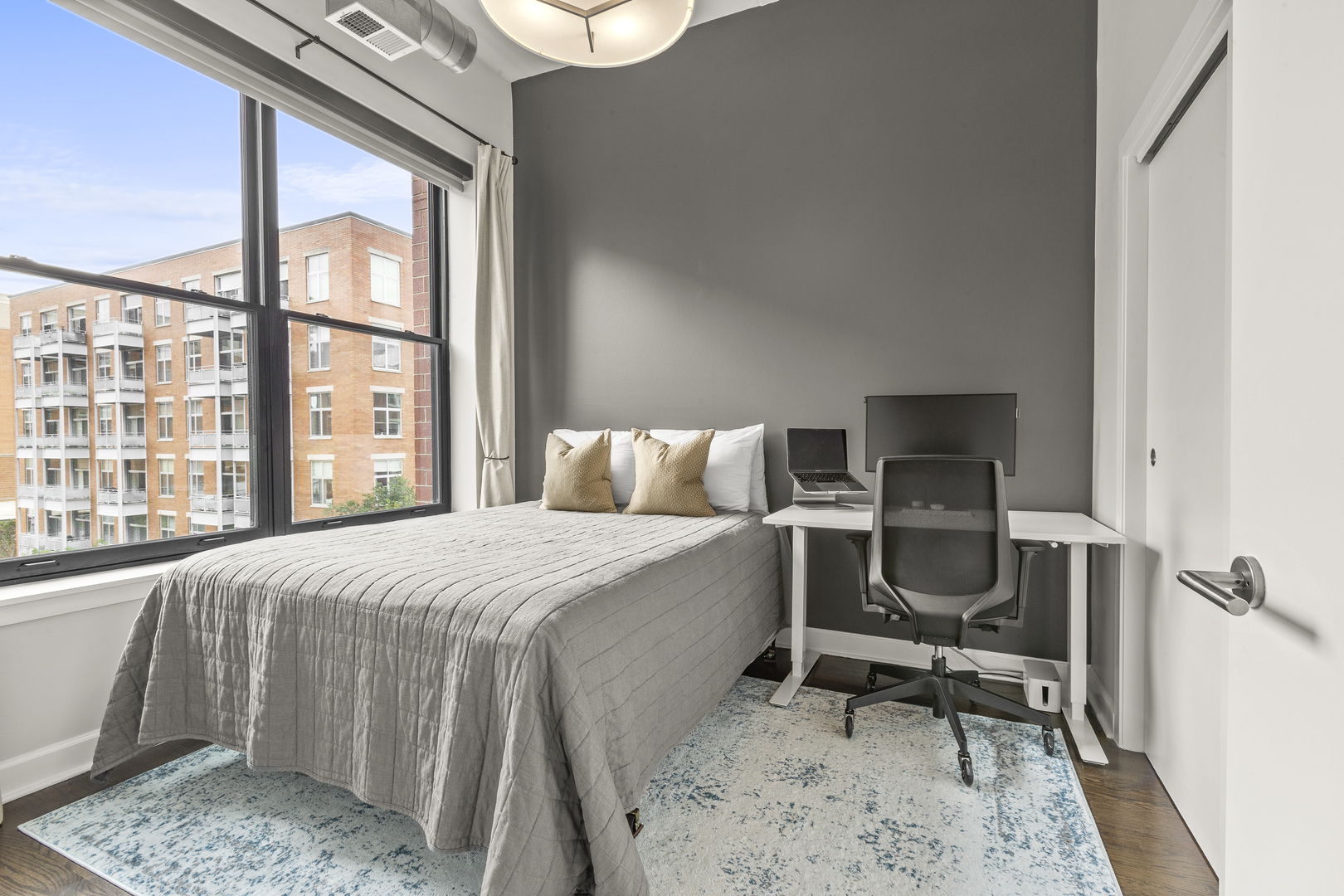 936 West Madison Street, Unit E4 Chicago, IL 60607 - Photo 18 of 21 a bed sitting in a bedroom next to a window