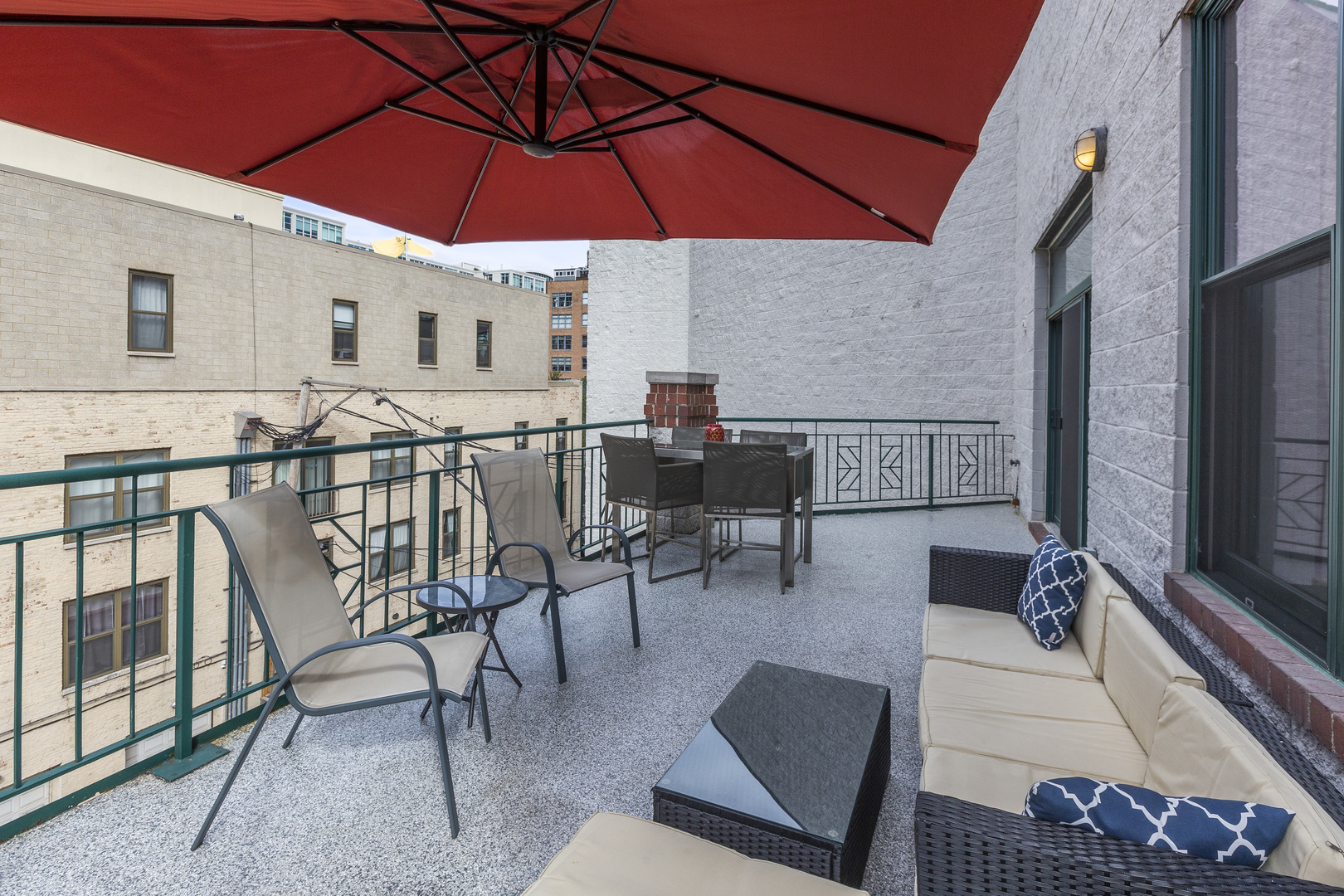 936 West Madison Street, Unit E4 Chicago, IL 60607 - Photo 20 of 21 a view of a patio with a table and chairs under an umbrella