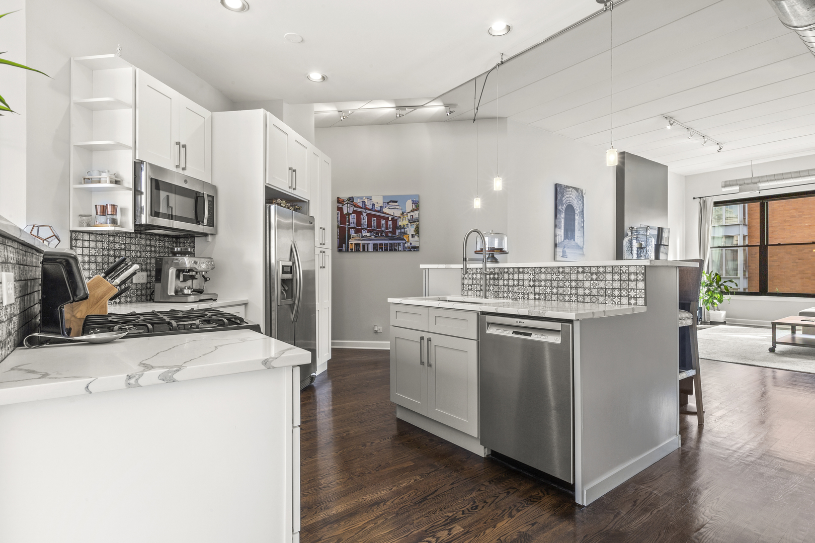 936 West Madison Street, Unit E4 Chicago, IL 60607 - Photo 8 of 21 a kitchen with stainless steel appliances kitchen island granite countertop a stove and a sink