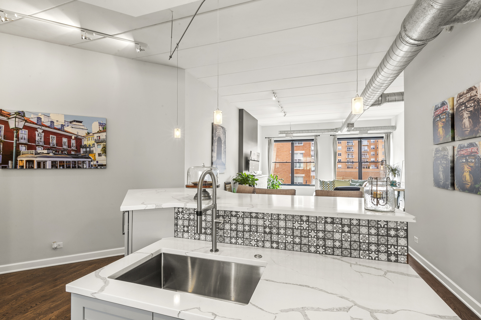 936 West Madison Street, Unit E4 Chicago, IL 60607 - Photo 9 of 21 a kitchen with a stove and white cabinets with wooden floor