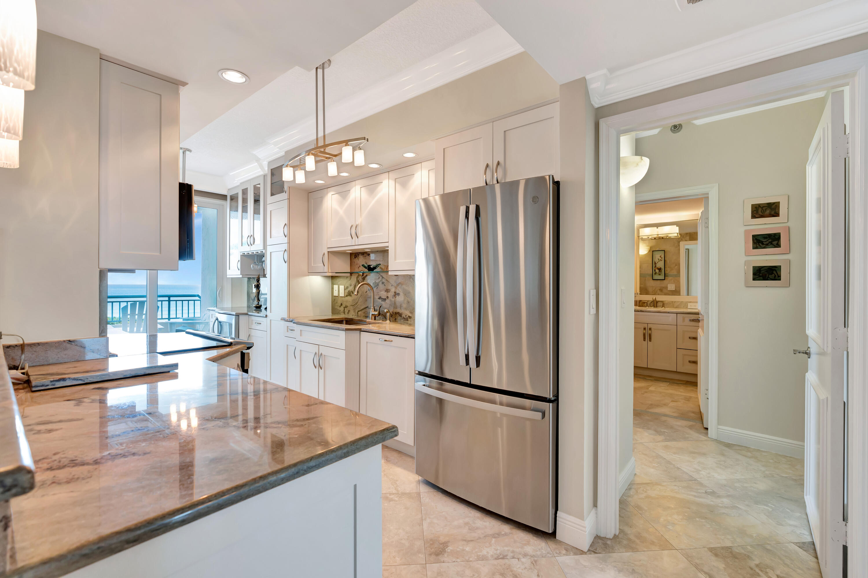 2000 Florida A1A, Unit N507 Jupiter, FL 33477 - Photo 23 of 78 a kitchen with stainless steel appliances granite countertop a refrigerator and a sink