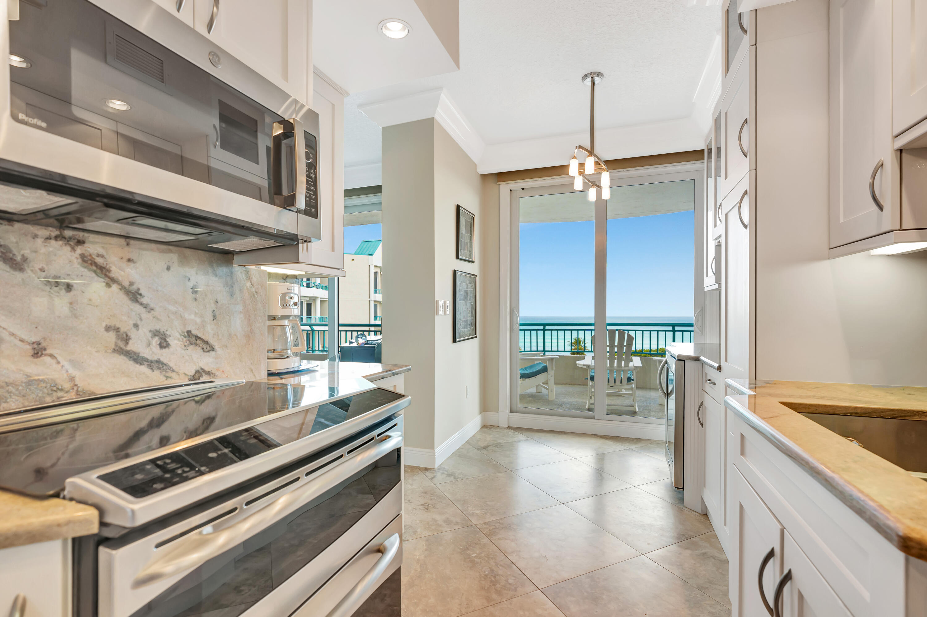 2000 Florida A1A, Unit N507 Jupiter, FL 33477 - Photo 25 of 78 a kitchen with a stove a sink and a refrigerator