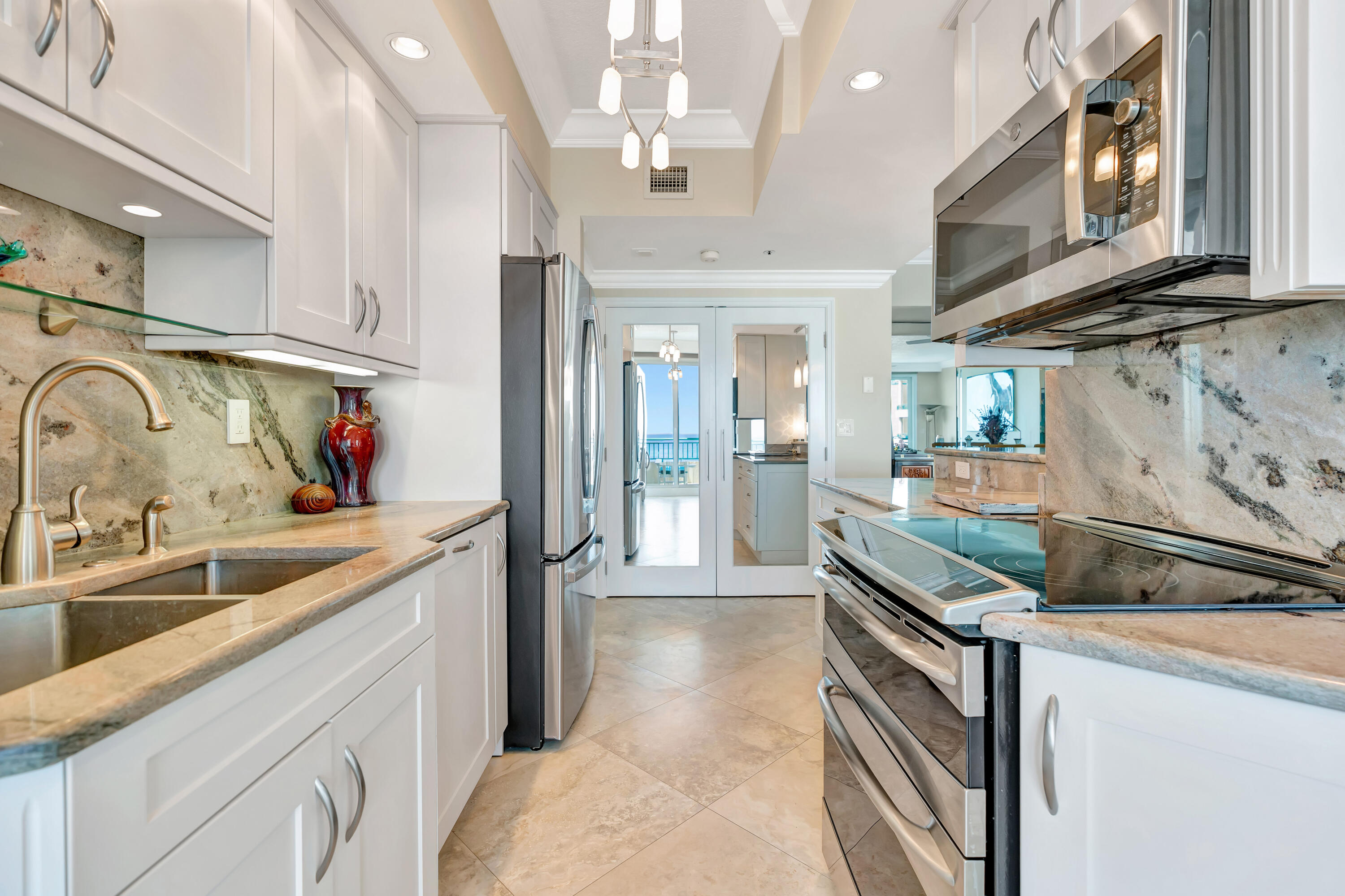 2000 Florida A1A, Unit N507 Jupiter, FL 33477 - Photo 26 of 78 a kitchen with stainless steel appliances granite countertop a sink and a stove