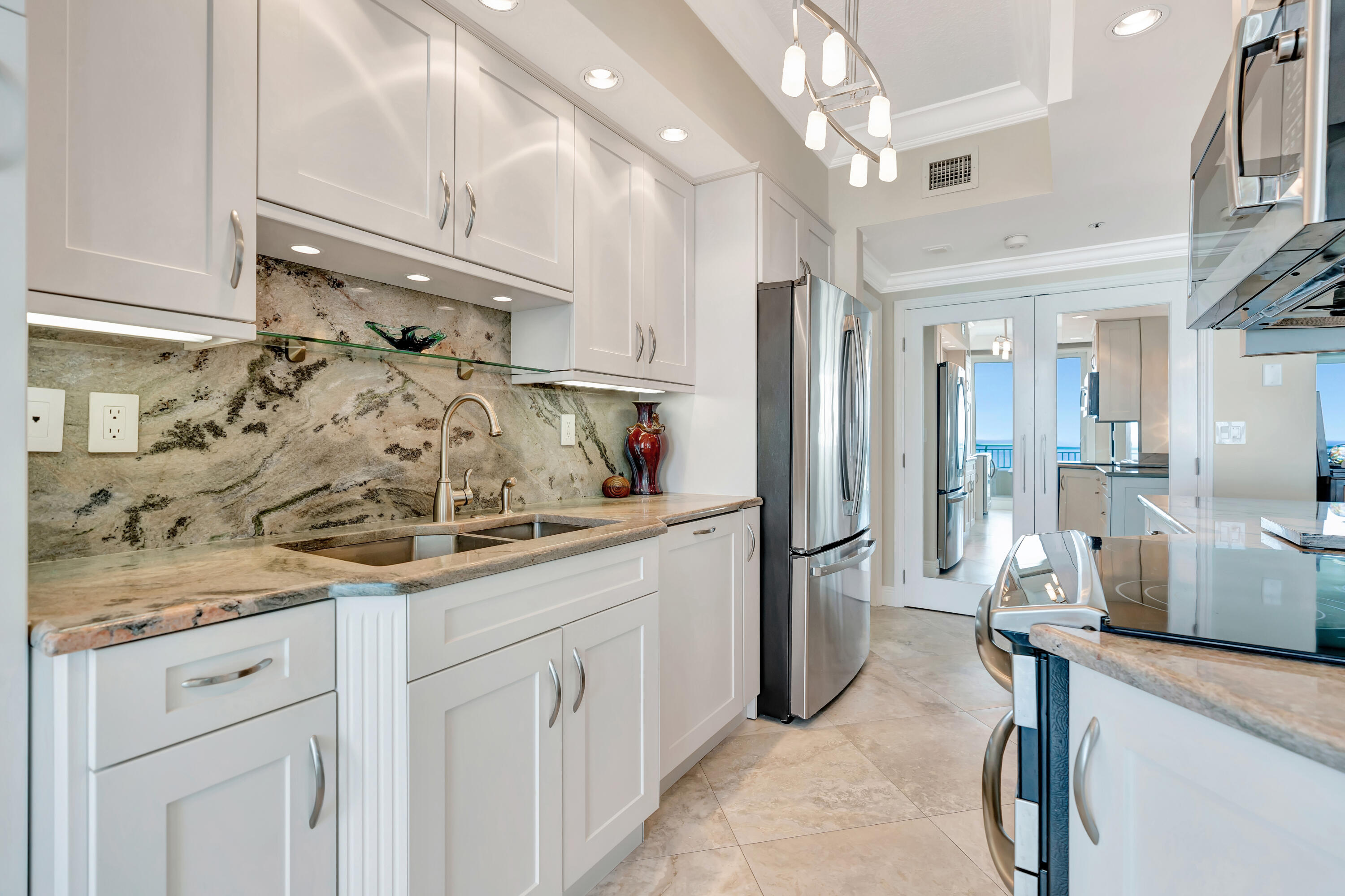 2000 Florida A1A, Unit N507 Jupiter, FL 33477 - Photo 27 of 78 a kitchen with a sink stainless steel appliances and cabinets