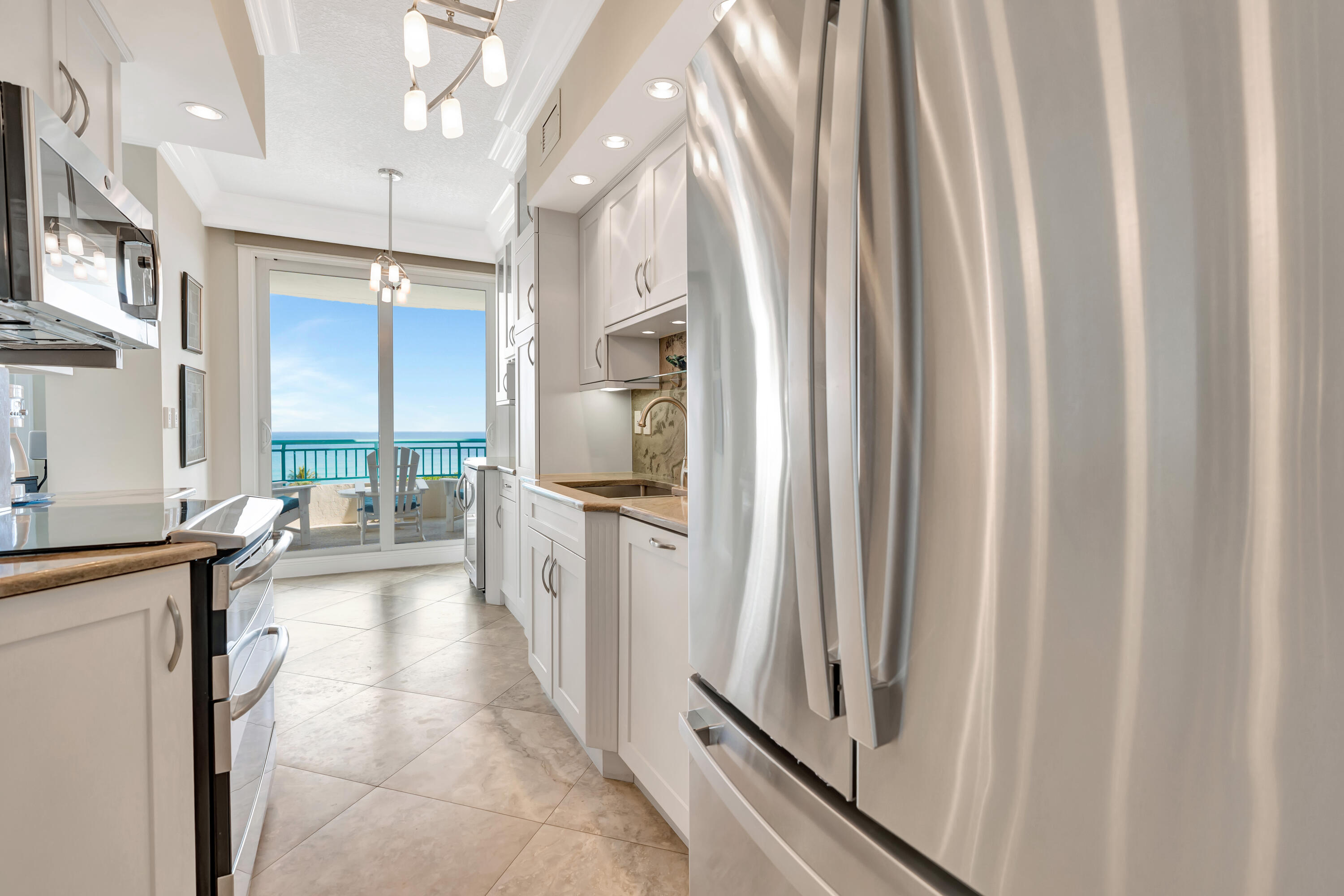 2000 Florida A1A, Unit N507 Jupiter, FL 33477 - Photo 29 of 78 a kitchen with sink a refrigerator and a stove