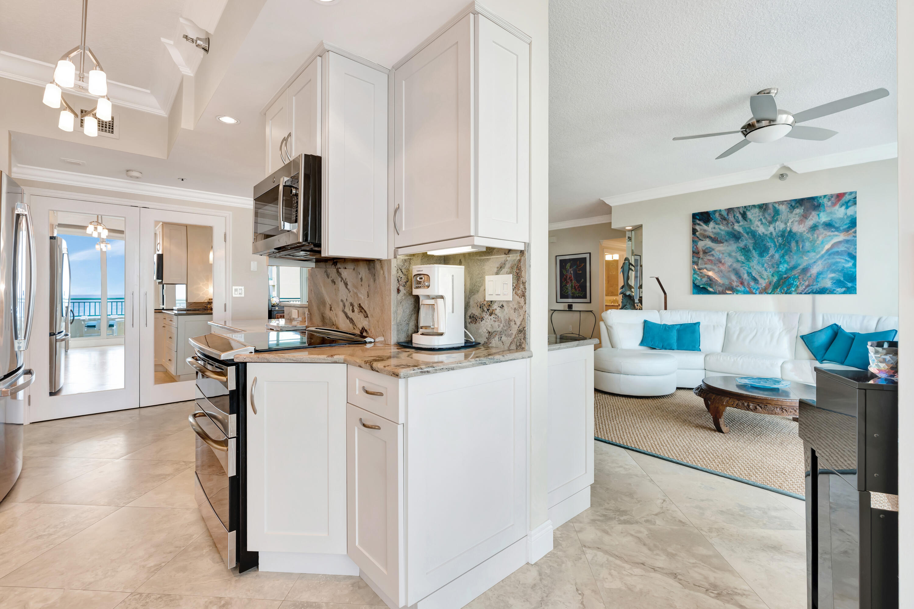 2000 Florida A1A, Unit N507 Jupiter, FL 33477 - Photo 33 of 78 a kitchen with stainless steel appliances kitchen island granite countertop a sink and cabinets