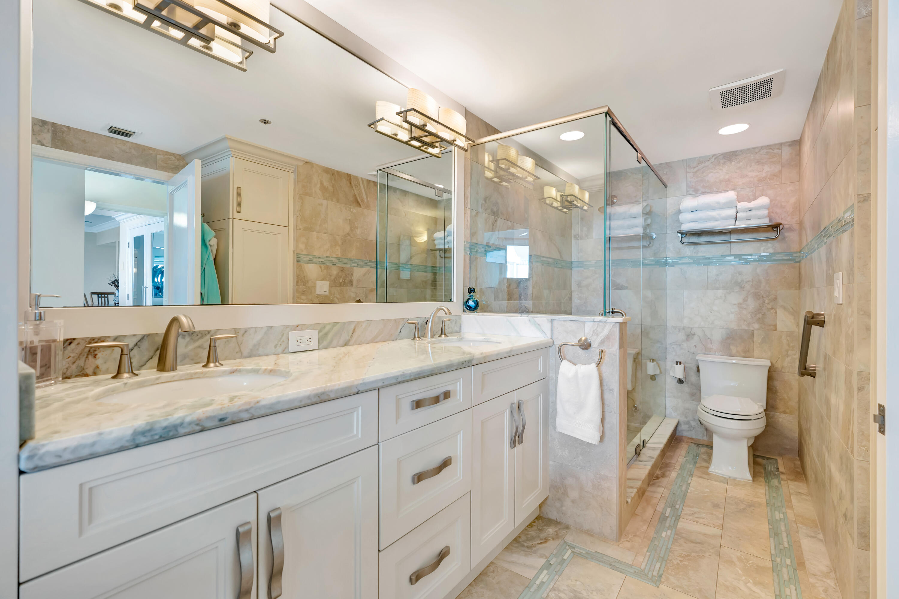 2000 Florida A1A, Unit N507 Jupiter, FL 33477 - Photo 43 of 78 a bathroom with a granite countertop sink mirror and a toilet