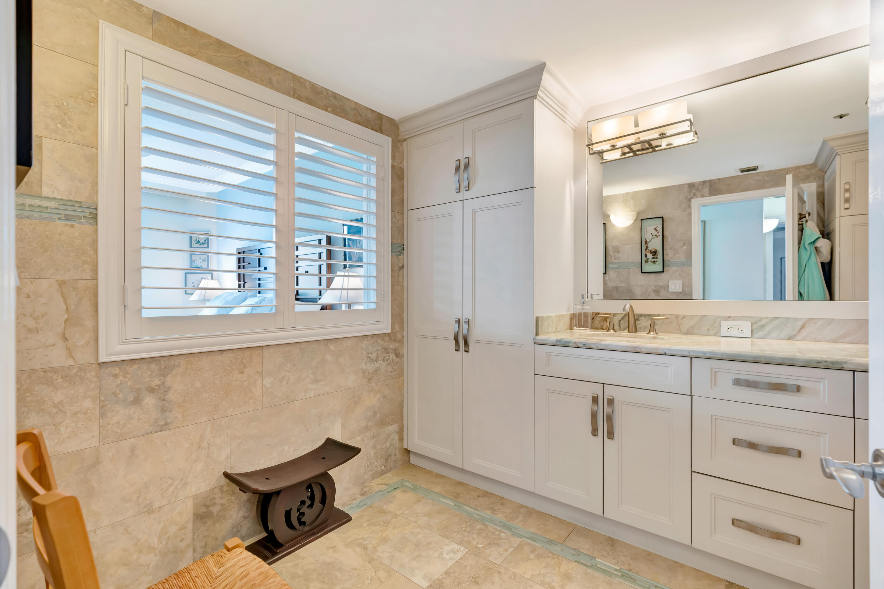 2000 Florida A1A, Unit N507 Jupiter, FL 33477 - Photo 45 of 78 a bathroom with a sink and a mirror