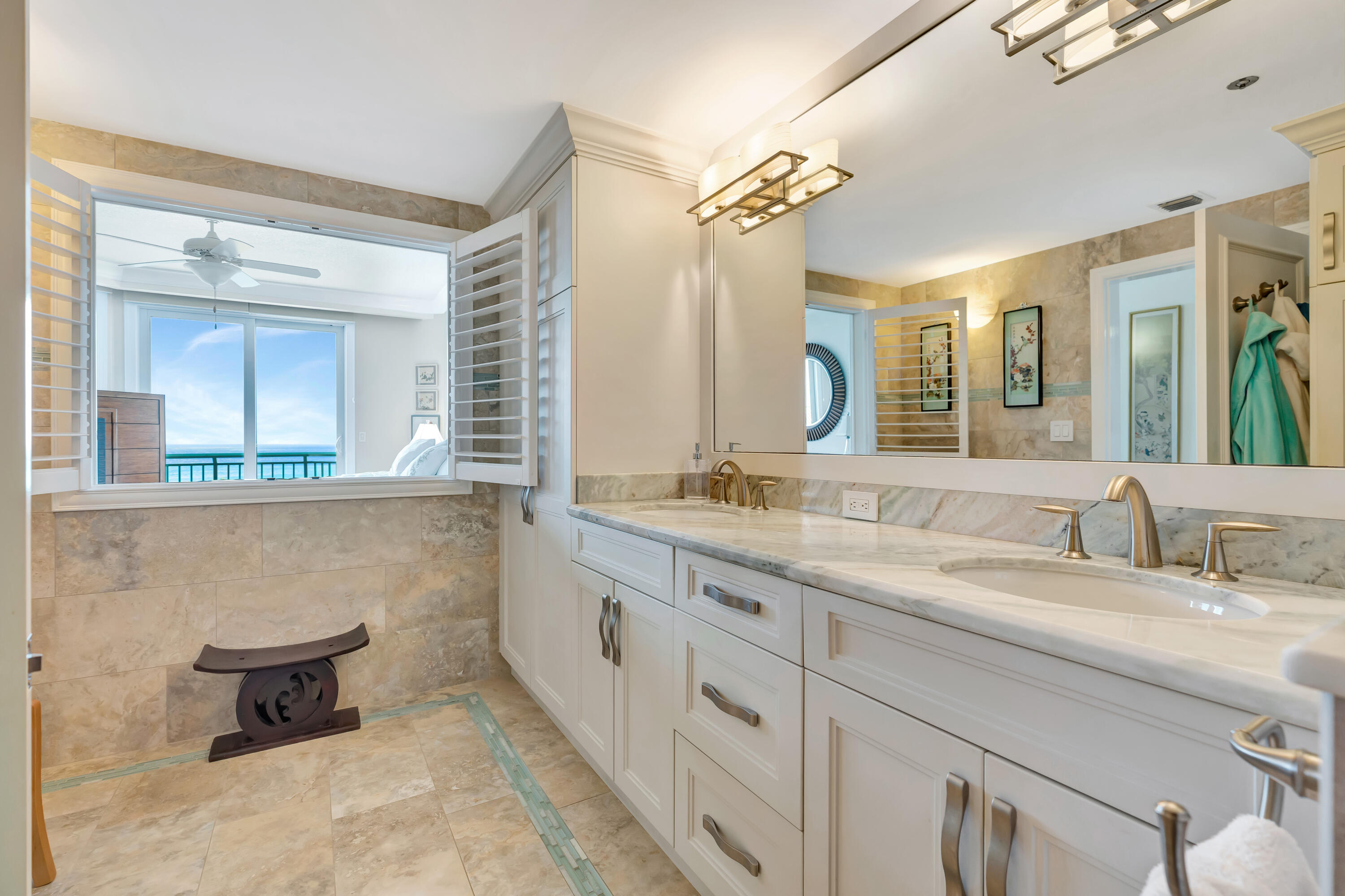 2000 Florida A1A, Unit N507 Jupiter, FL 33477 - Photo 46 of 78 a bathroom with a granite countertop sink mirror and