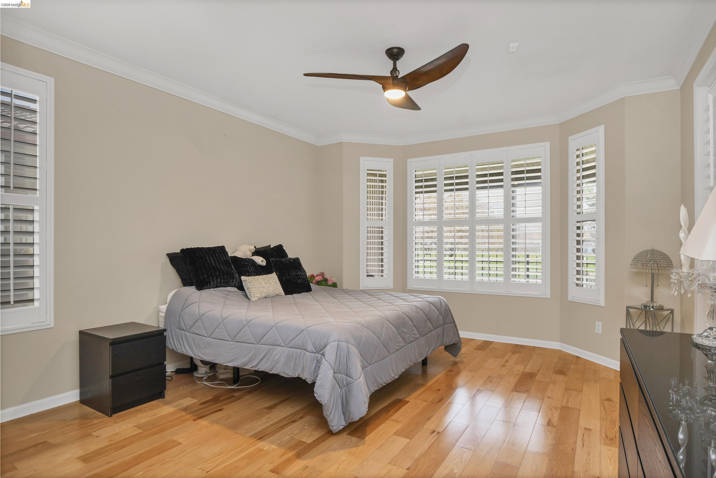 342 Desert Forest Court Rio Vista, CA 94571 - Photo 30 of 40 Bedroom with light wood-type flooring, crown molding, and a ceiling fan