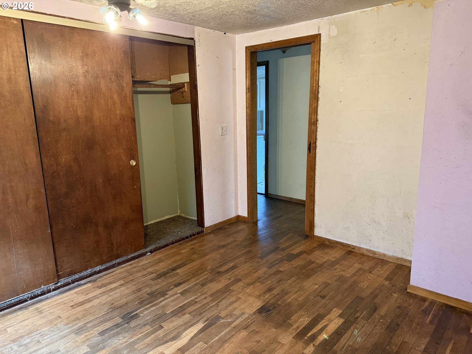 7451 Southeast Johnson Street Hillsboro, OR 97123 - Photo 14 of 27 an empty room with wooden floor and a bathroom
