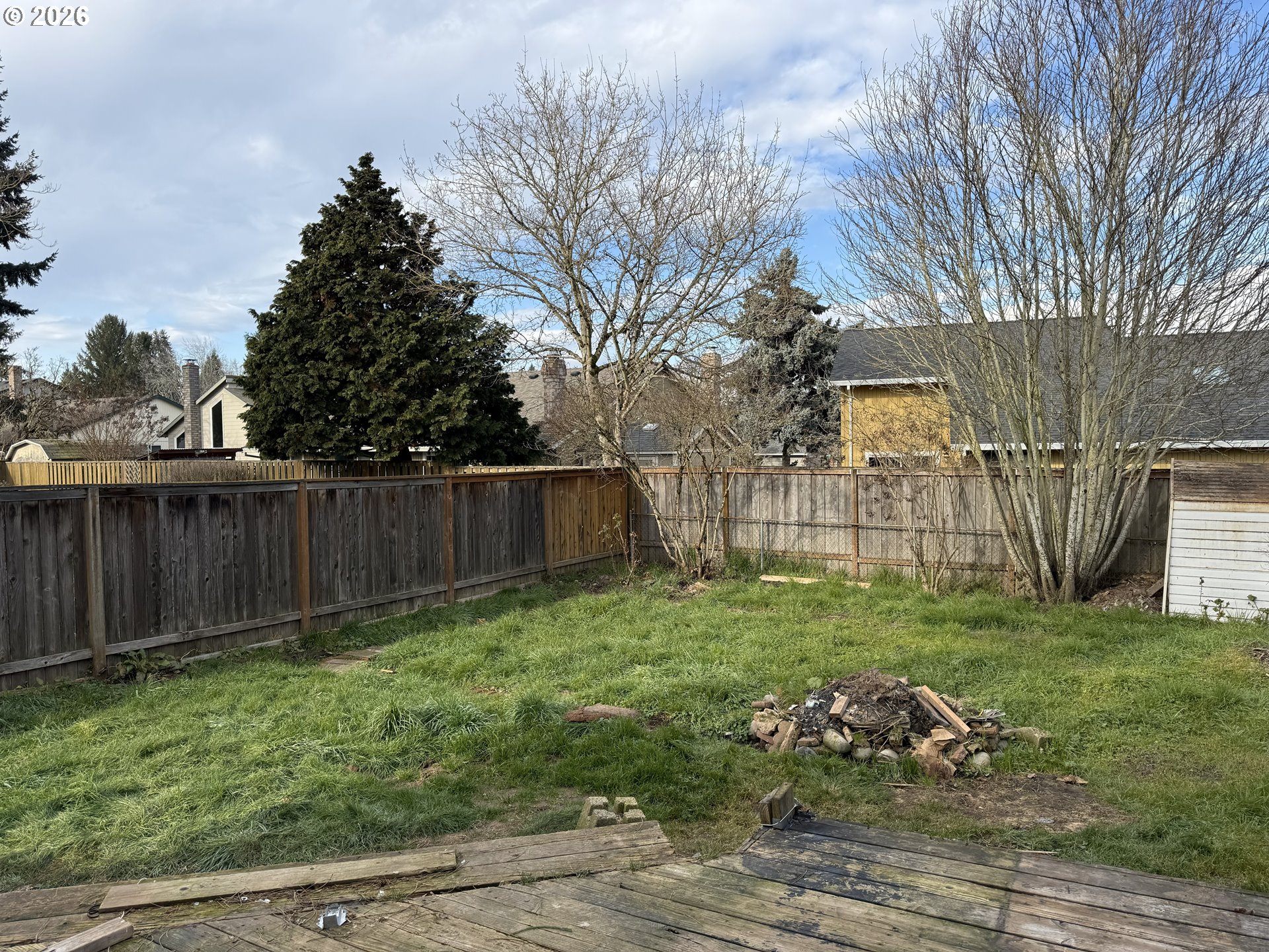7451 Southeast Johnson Street Hillsboro, OR 97123 - Photo 23 of 27 a view of a backyard with plants and large trees