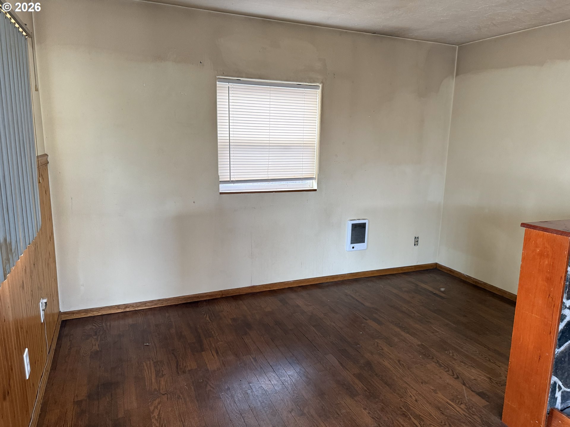 7451 Southeast Johnson Street Hillsboro, OR 97123 - Photo 3 of 27 an empty room with wooden floor and windows
