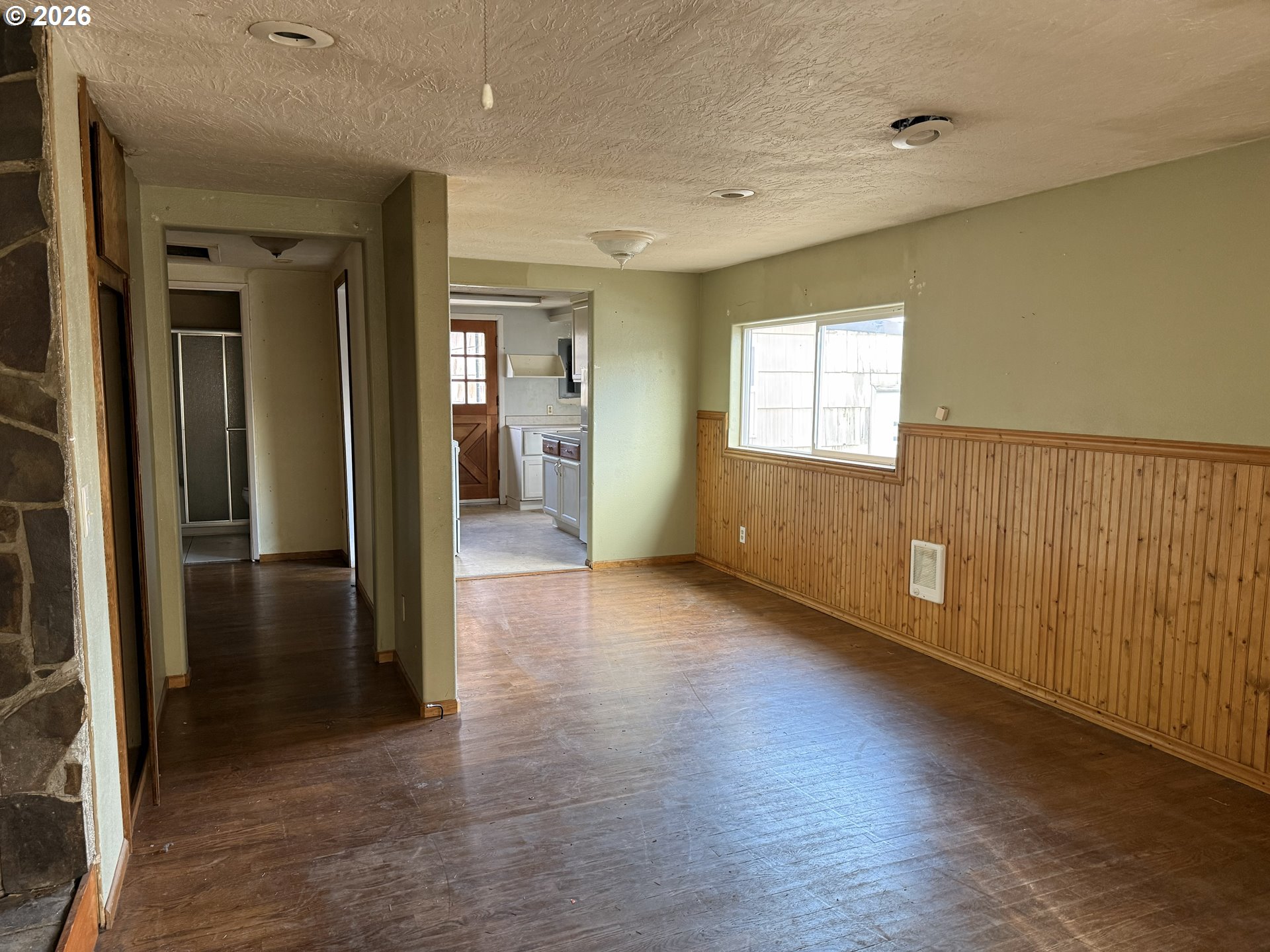 7451 Southeast Johnson Street Hillsboro, OR 97123 - Photo 6 of 27 an empty room with wooden floor and windows
