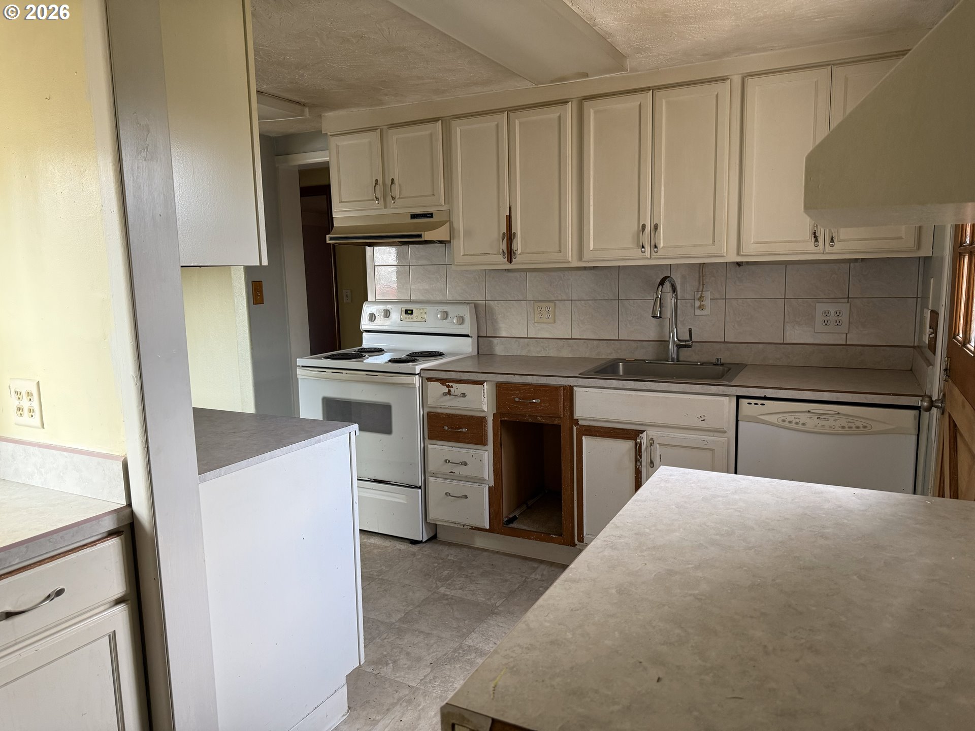 7451 Southeast Johnson Street Hillsboro, OR 97123 - Photo 9 of 27 a kitchen with stainless steel appliances granite countertop a stove sink and cabinets