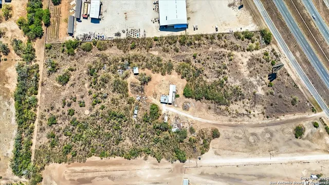 an aerial view of residential houses with outdoor space