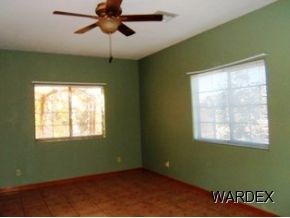 7945 South Hawk Road Kingman, AZ 86401 - Photo 17 of 24 a view of an empty room with a window and a fan