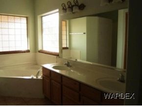 7945 South Hawk Road Kingman, AZ 86401 - Photo 8 of 24 a bathroom with a sink and a bathtub