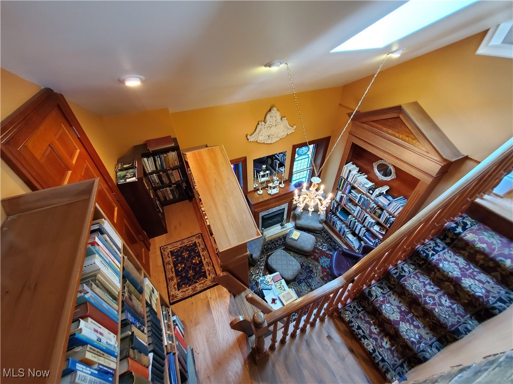150 Main Street Hayesville, OH 44805 - Photo 17 of 50 Study #1 area with stairs, wood finished floors, a fireplace, high vaulted ceiling, and a skylight