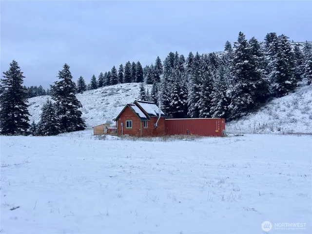 a wooden bench sitting in the middle of a field