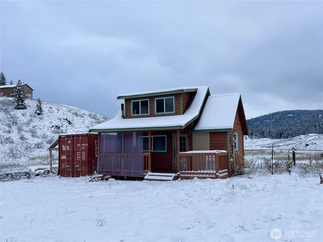 a view of a house with wooden walls and stairs