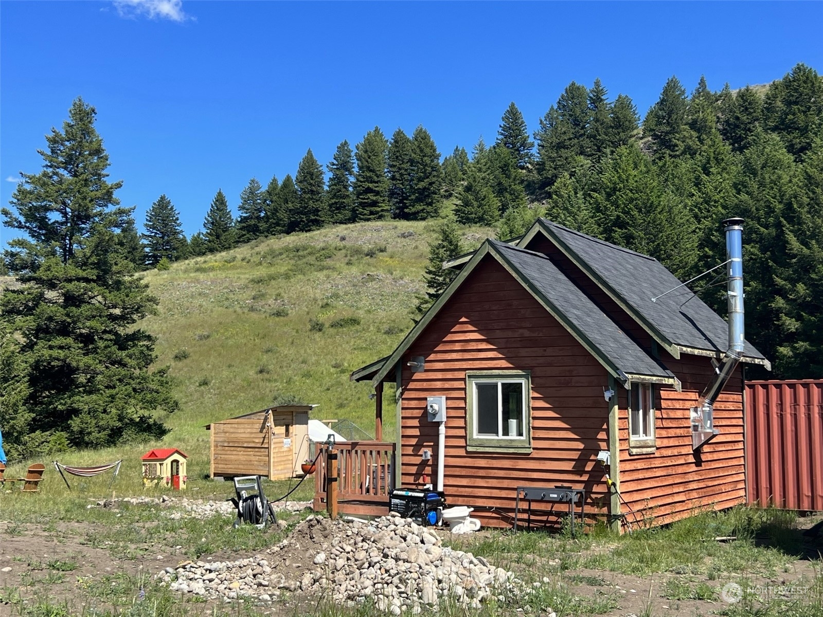 2 Mountain View Drive Oroville, WA 98844 - Photo 10 of 26 a view of house with backyard space and garden