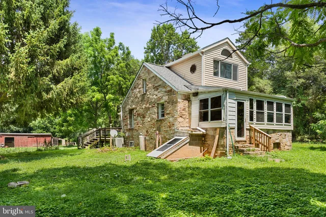 a front view of a house with a yard and green space