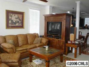 152 Singleton Road Mooresville, NC 28117 - Photo 2 of 6 a living room with furniture a dining table and a fireplace