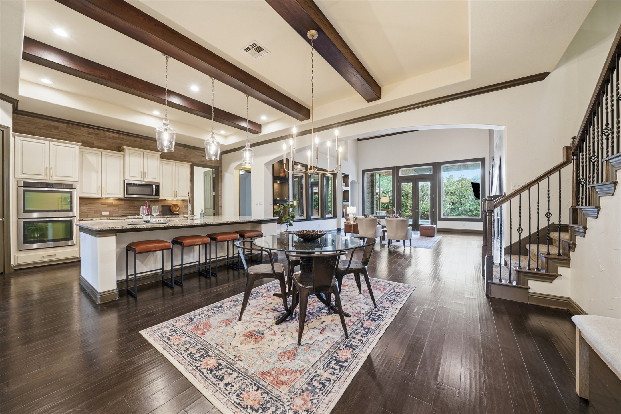 8729 Vantage Point Drive Austin, TX 78737 - Photo 10 of 33 Rich hardwood floors flow through an open-concept living space with a gourmet kitchen and a graceful staircase.