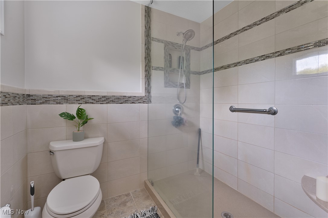 7091 South Raccoon Road Canfield, OH 44406 - Photo 29 of 39 Bathroom with a tile shower and toilet