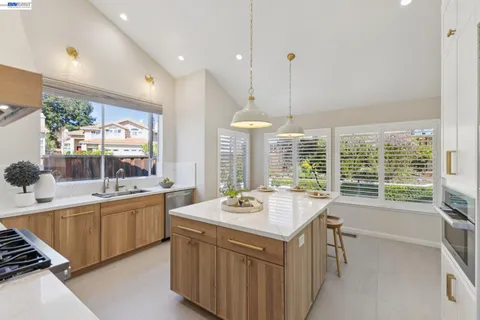 a kitchen with a sink and a large window