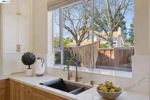 a kitchen with a table a refrigerator and cabinets