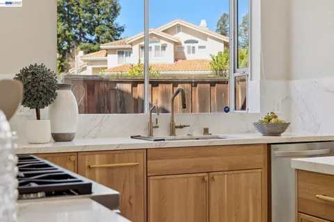 a kitchen with stainless steel appliances granite countertop a stove and a sink