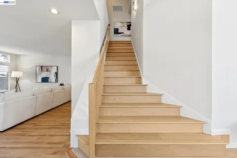 a spacious bathroom with a granite countertop sink mirror and shower