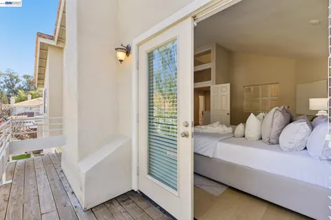 a bedroom with a bed and a table chair