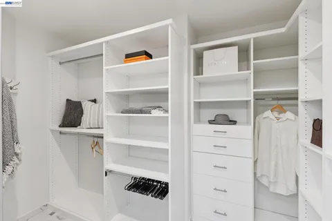 a bathroom with a double vanity sink toilet and shower