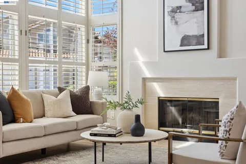 a living room with furniture a window and a fireplace