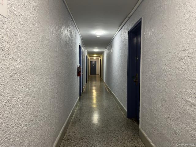 1332 Metropolitan Avenue, Unit 6A Bronx, NY 10462 - Photo 5 of 11 Hallway with a textured wall and light aggregate flooring