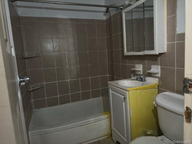 1332 Metropolitan Avenue, Unit 6A Bronx, NY 10462 - Photo 10 of 11 Bathroom with shower combination, vanity, tile walls, and decorative backsplash
