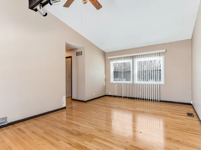 a view of an empty room with glass door