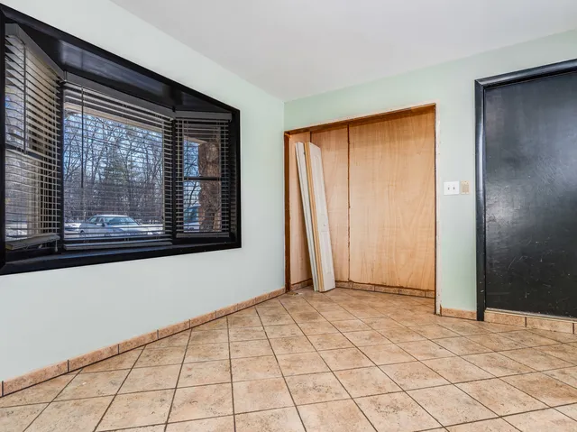 a view of washer and dryer with bathroom in the background