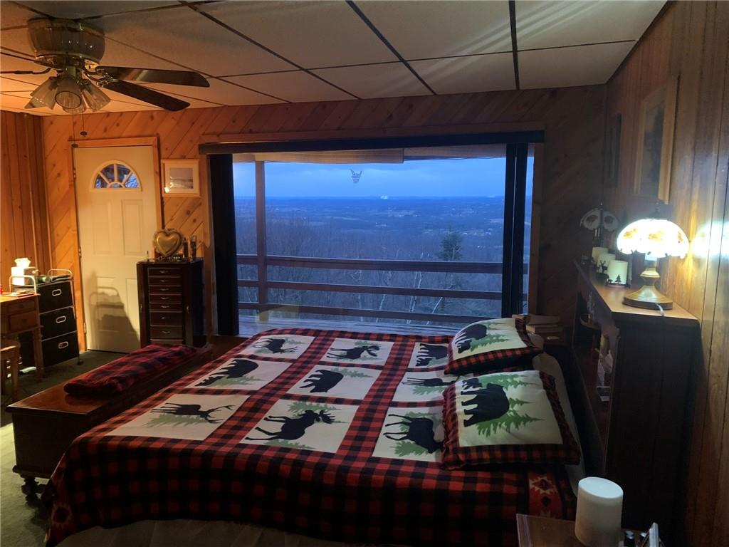 235 Pine Knob Road Hopwood, PA 15445 - Photo 20 of 39 a bedroom with a bed and a chandelier
