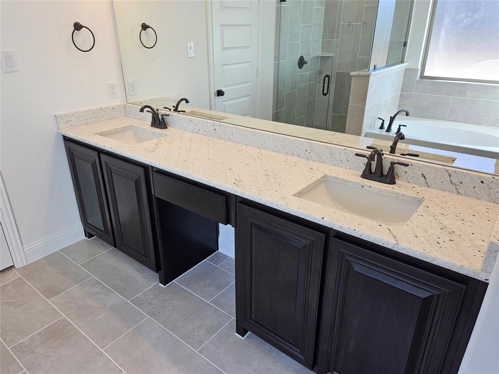 1507 Enloe Road Howe, TX 75459 - Photo 16 of 27 a bathroom with a sink and a mirror