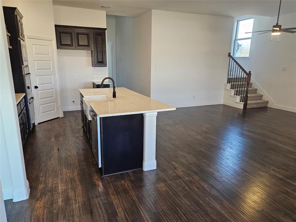 1507 Enloe Road Howe, TX 75459 - Photo 6 of 27 a view of a kitchen with wooden floor and electronic appliances