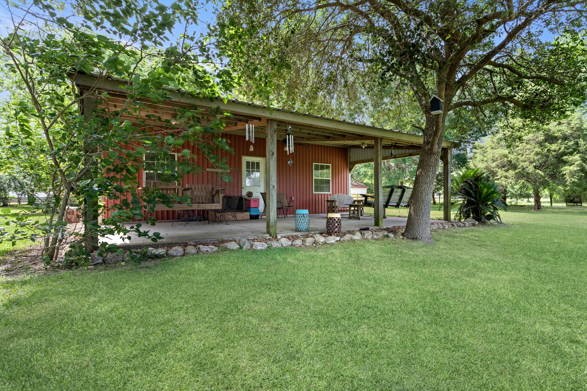 1747 Farm To Market Road 365 Nome, TX 77629 - Photo 3 of 24 a view of a house with backyard sitting area and garden