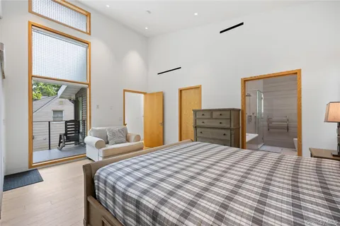 a bedroom with a large bed and a chandelier