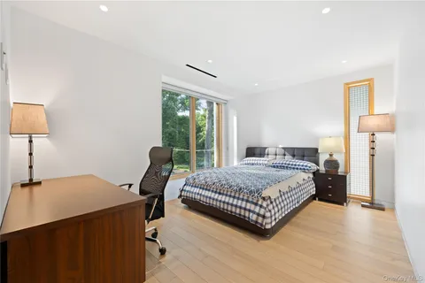 a bedroom with a bed window and a table