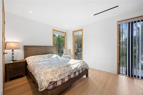 a bedroom with a bed and a night stand