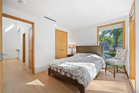 a bedroom with a bed and a view of outdoor