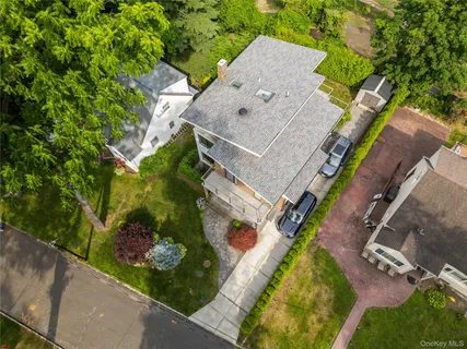 an aerial view of a house with a yard and garden